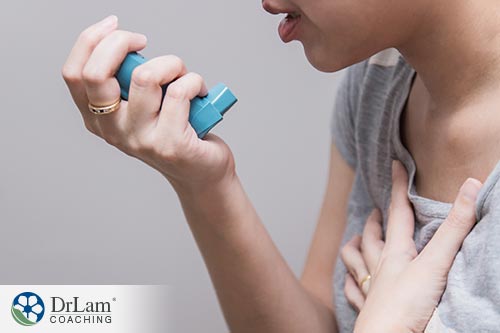 An image of a woman using an inhailer