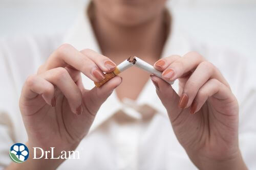 An image of a woman breaking cigarette