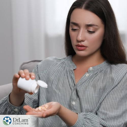 An image of a woman drinking a supplement