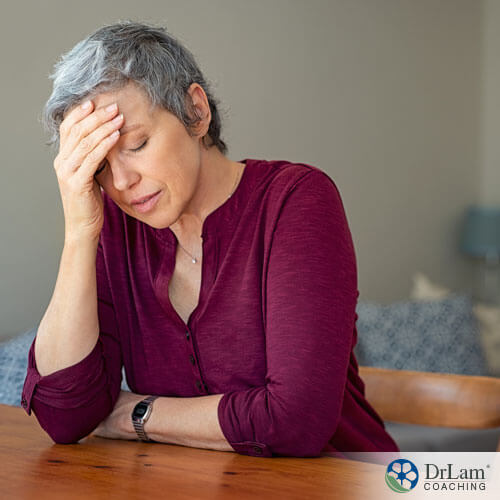 An image of an older woman holding her head