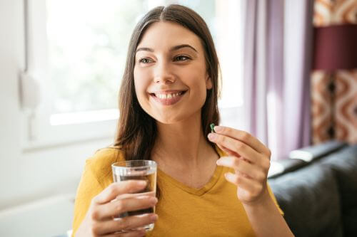 An image of a person taking supplements for pyroluria